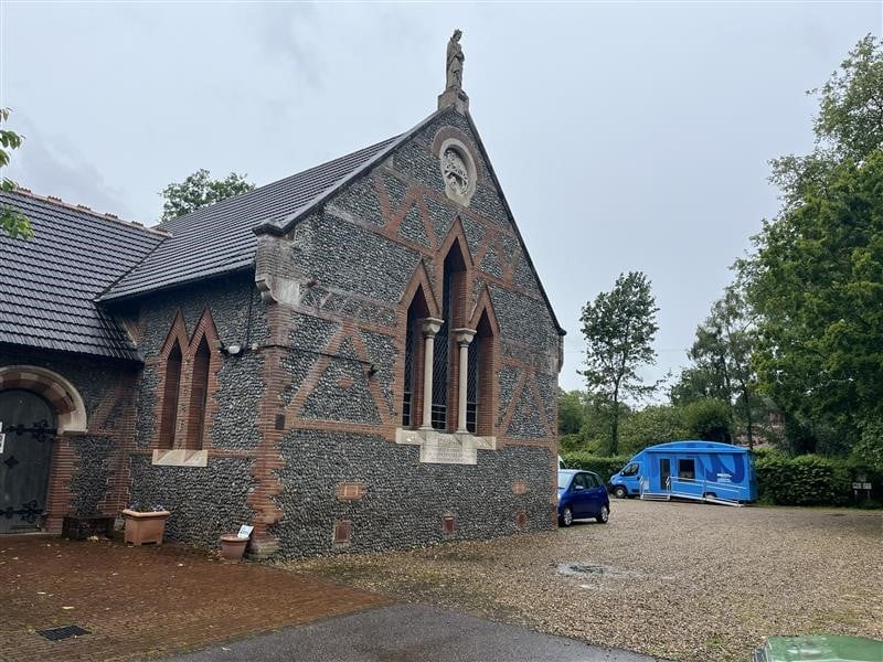 Carton van outside church building