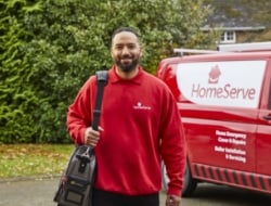 man in HomeServe uniform standing next to van